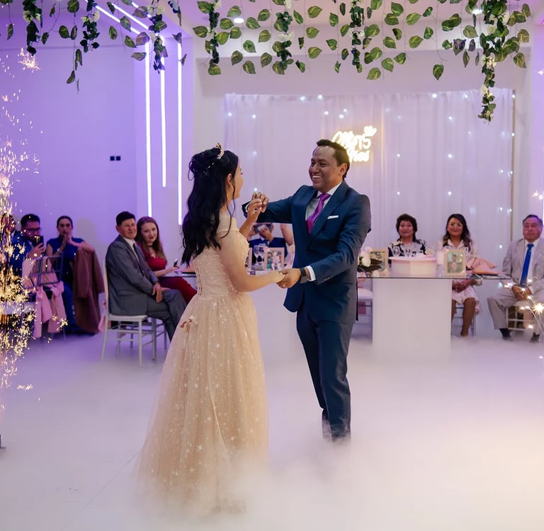 Fotografía de padre bailando el vals con la quinceañera con pirotécnia y humo en Quito, Ecuador