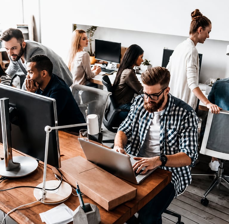 Software development team working on a secure creator platform in a modern office.