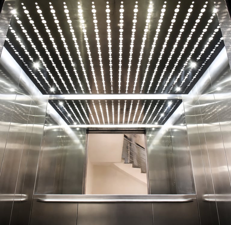 Modern passenger elevator with LED ceiling lighting and stainless steel interior