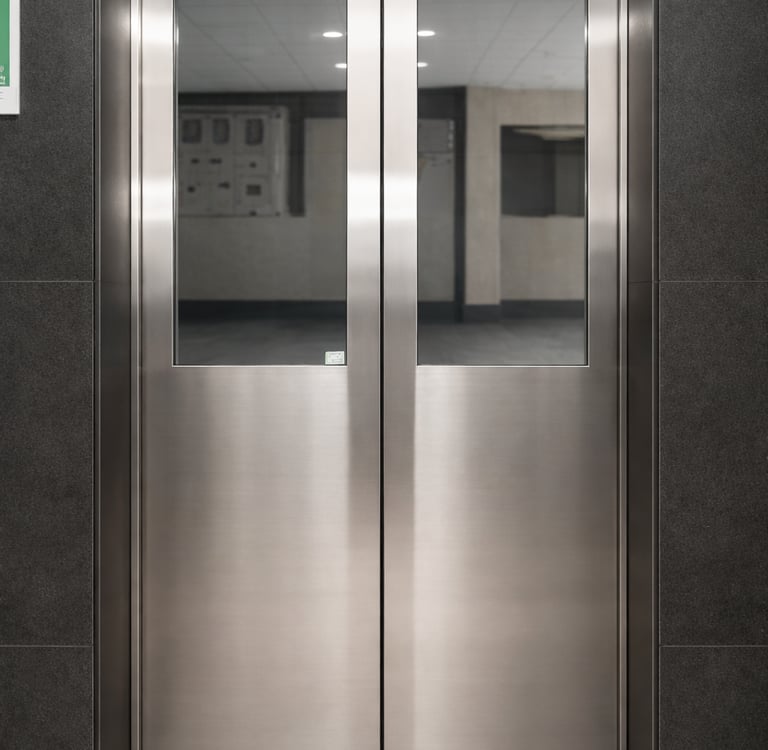 Automatic passenger elevator doors with glass panels designed by Stellify Elevators in India