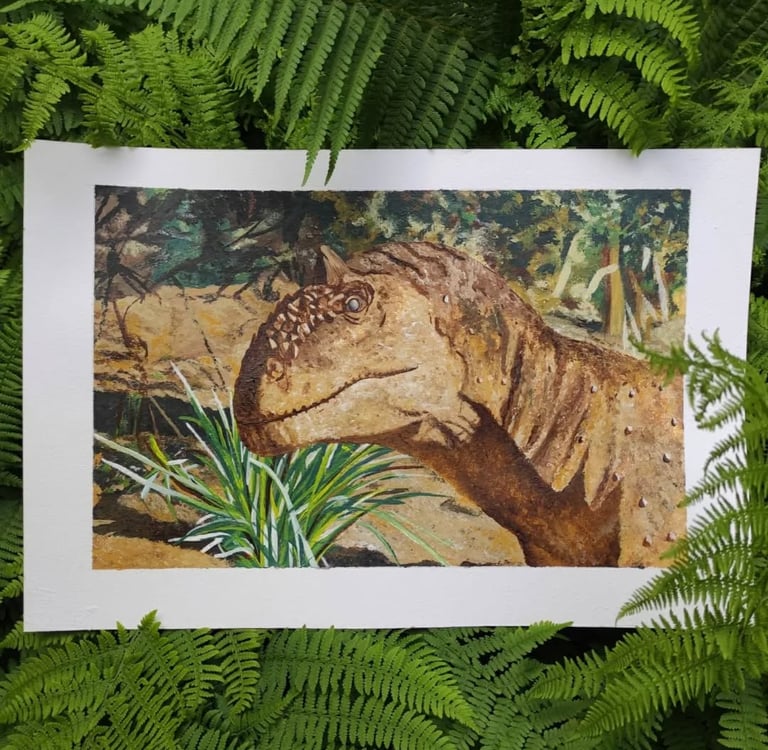 Profile view of a Majungasaurus head painted in acrylics, set against a green landscape.