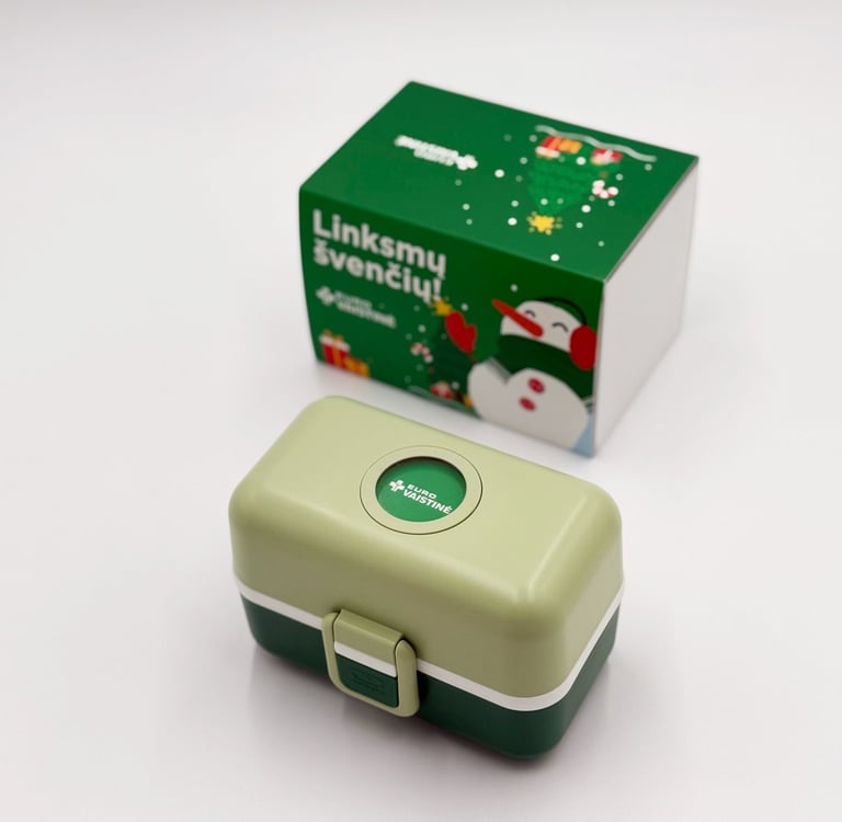Green and light green Eurovaistine lunch box with a snowman-themed holiday gift box.