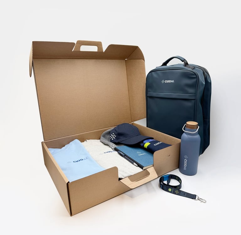 A corporate gift box set containing a branded backpack, water bottle, apparel, and stationery on white background.