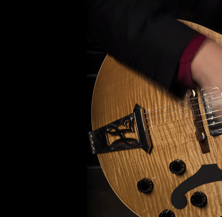 a hand rapidly strumming a guitar