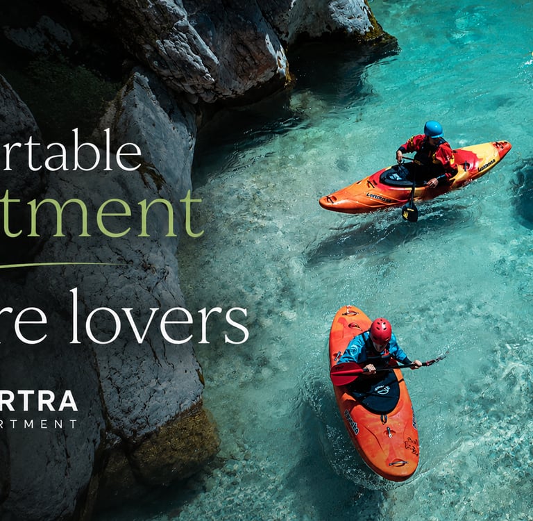 Kayakers paddling through turquoise river water near a comfortable nature apartment rental.
