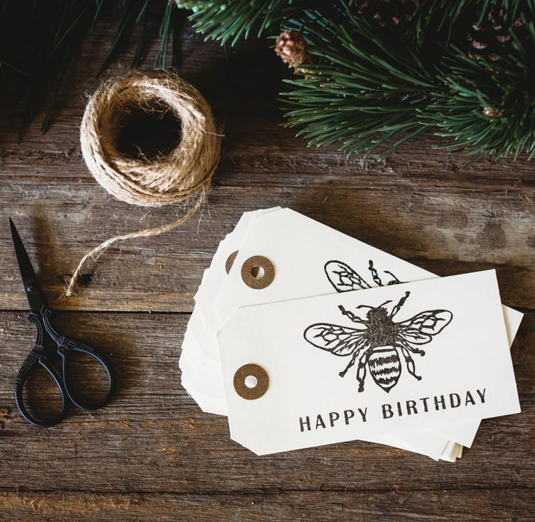 a pair of scissors and a roll of string on a wooden table