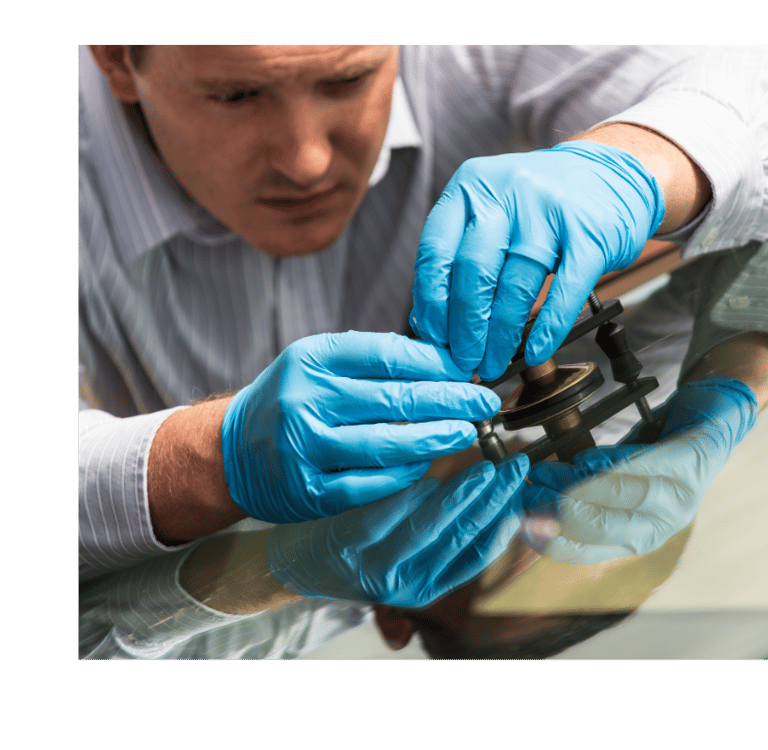 a man in gloves and gloves is holding a pair of scissors