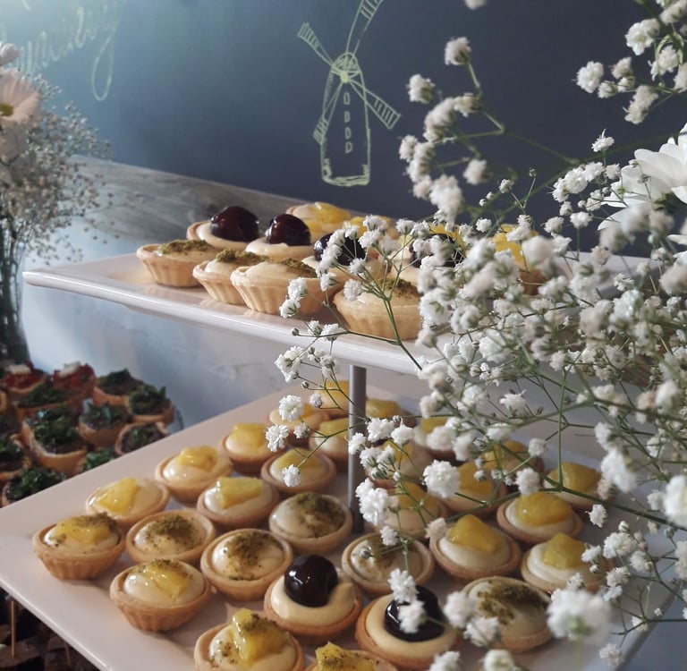 A colorful display of assorted homemade cookies and tarts arranged invitingly on a plate