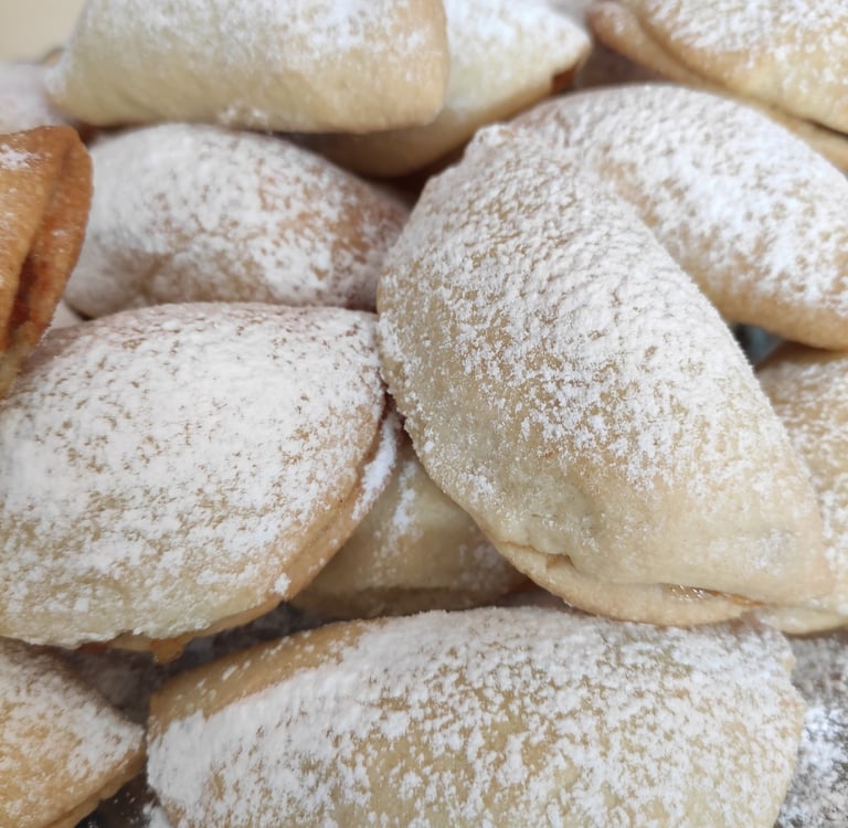 pudra şekeri ile süslenmiş yarım ay şeklinde elmalı kurabiye