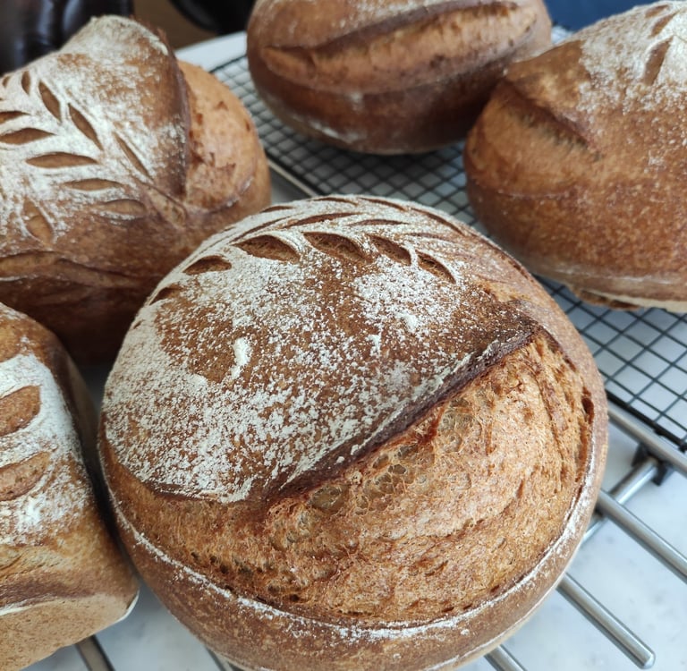 A  table with freshly baked sourdough bread and  in a cozy cafe setting.