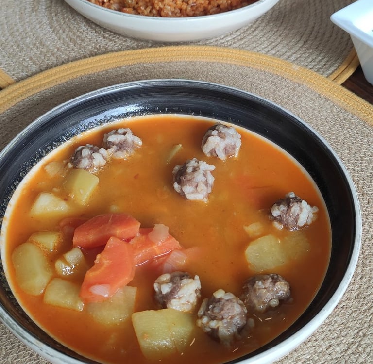 A warm plate of the day's hot meal served alongside fresh olive oil dishes, highlighting the cafe's homemade touch.