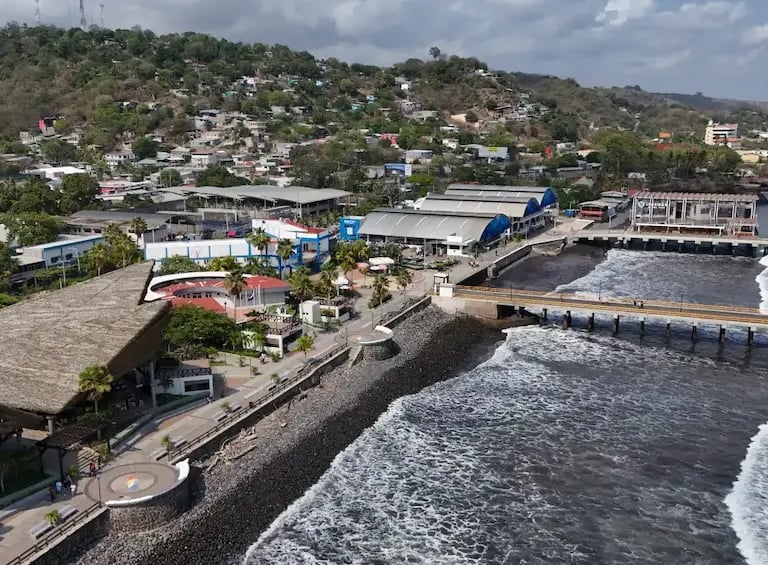 Aerial view of La Libertad pier and beach in El Salvador featuring the scenic coastal boardwalk and ocean waves.