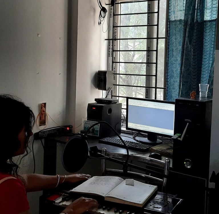 a woman sitting at a desk with a keyboard and a keyboard