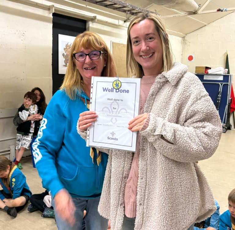 A certificate has been awarded by a beavers leader to Christine for painting the 25th Allerton Scout Hut