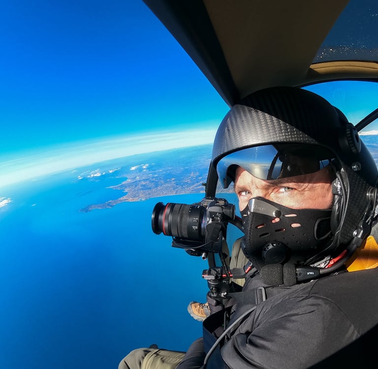 a man in a helmet and goggles is taking a picture of a man in