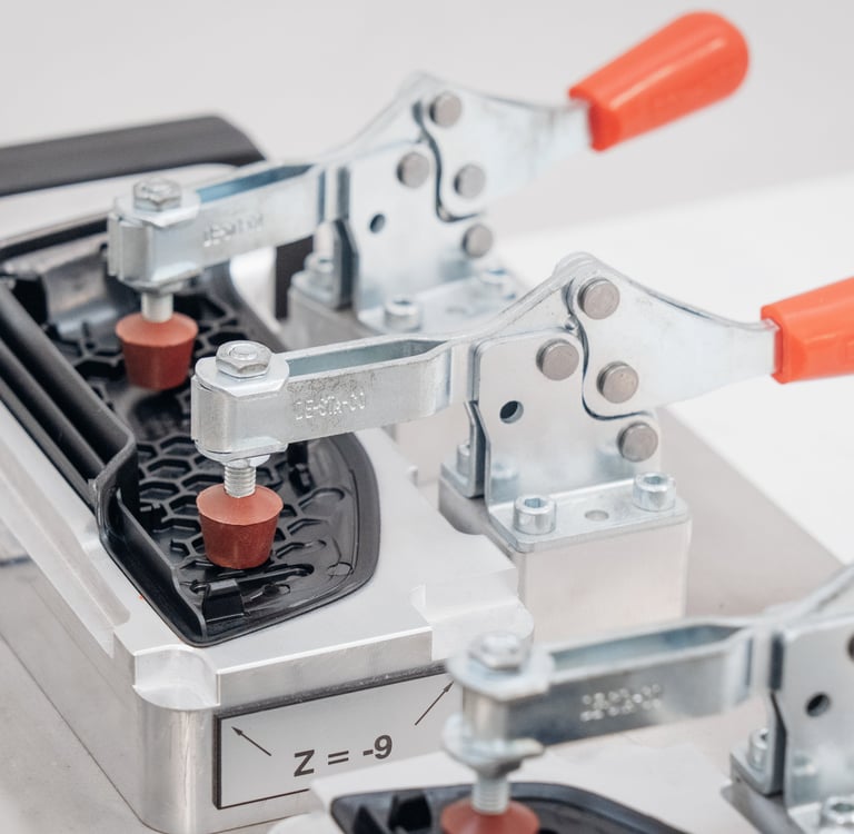 Fixture clamping plastic parts using over center clamps.