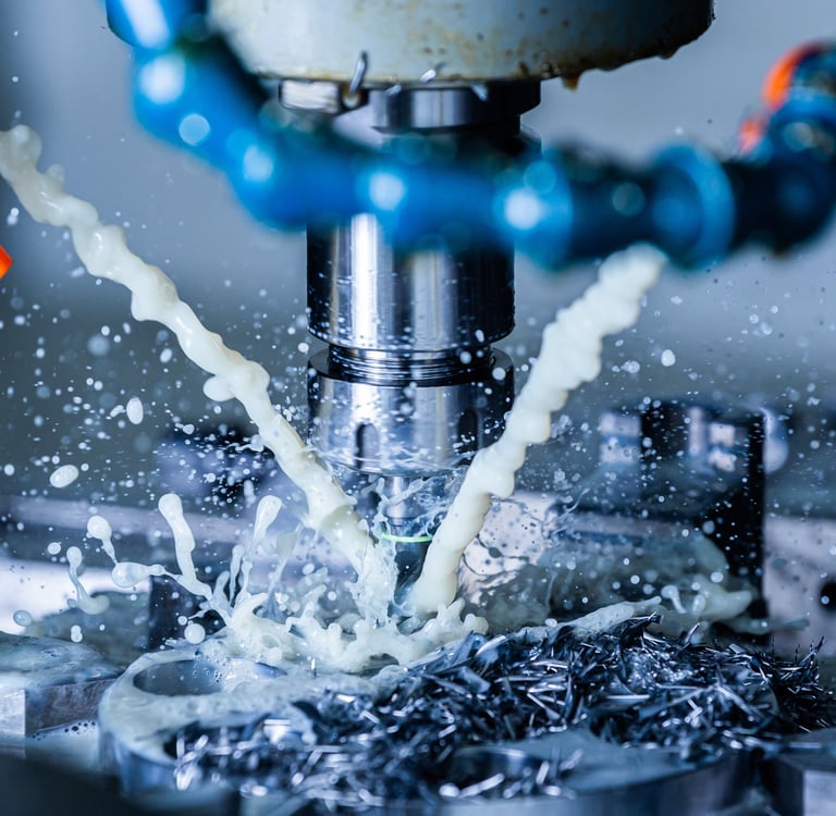 CNC machine tool machining a precision fixture, with coolant.