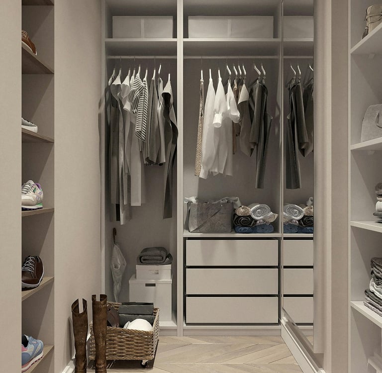 White wardrobe with white / grey tone clothes hanging, shoes, towels and drawersr
