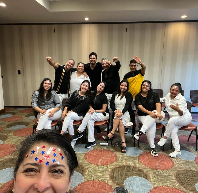 A diverse group of coworkers posing together for a team-building photo in a conference room.