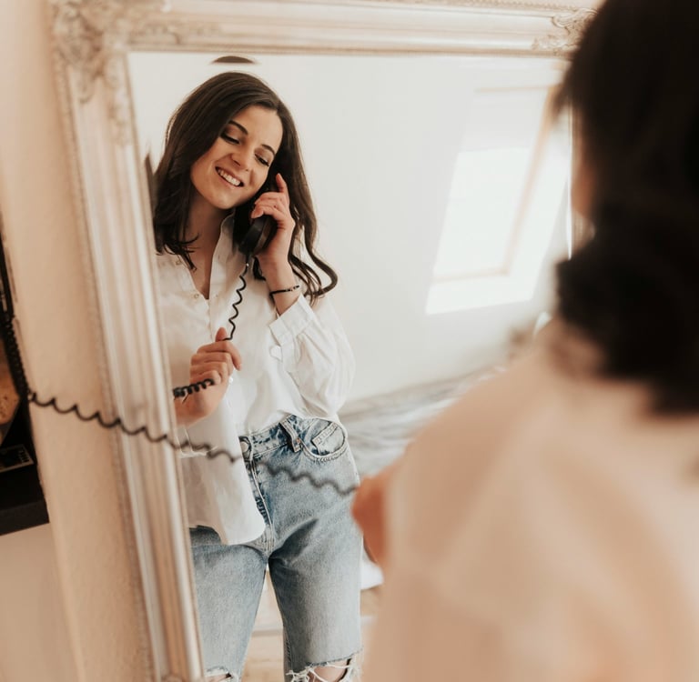 confident woman smiling getting ready for a first date looking in the mirror