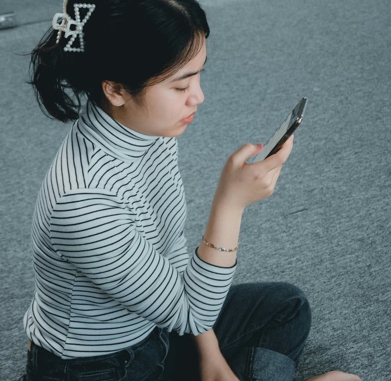 woman sitting calmly and confidently while checking her phone, not anxious