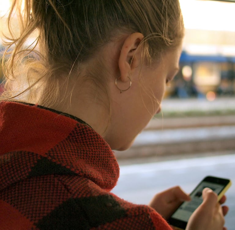 woman looking at phone with worried expression waiting for him to text back