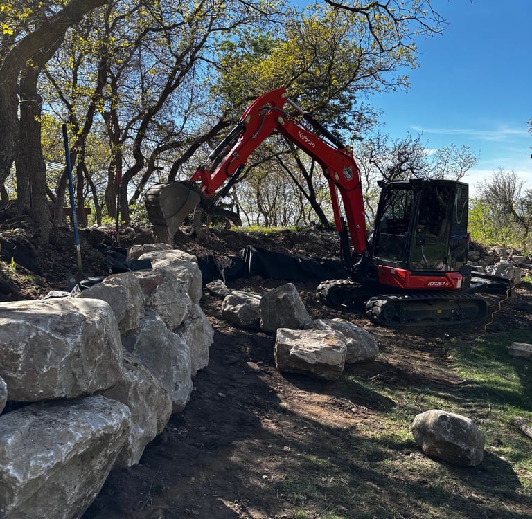 Kubota KX057-s building a boulder wall in northern Utah