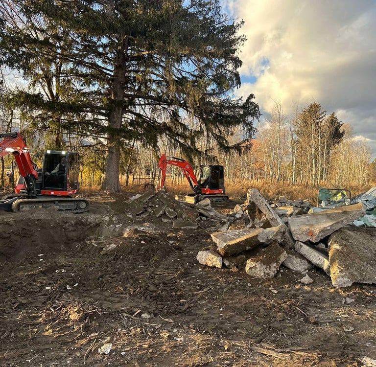 Kubota excavators digging up concrete