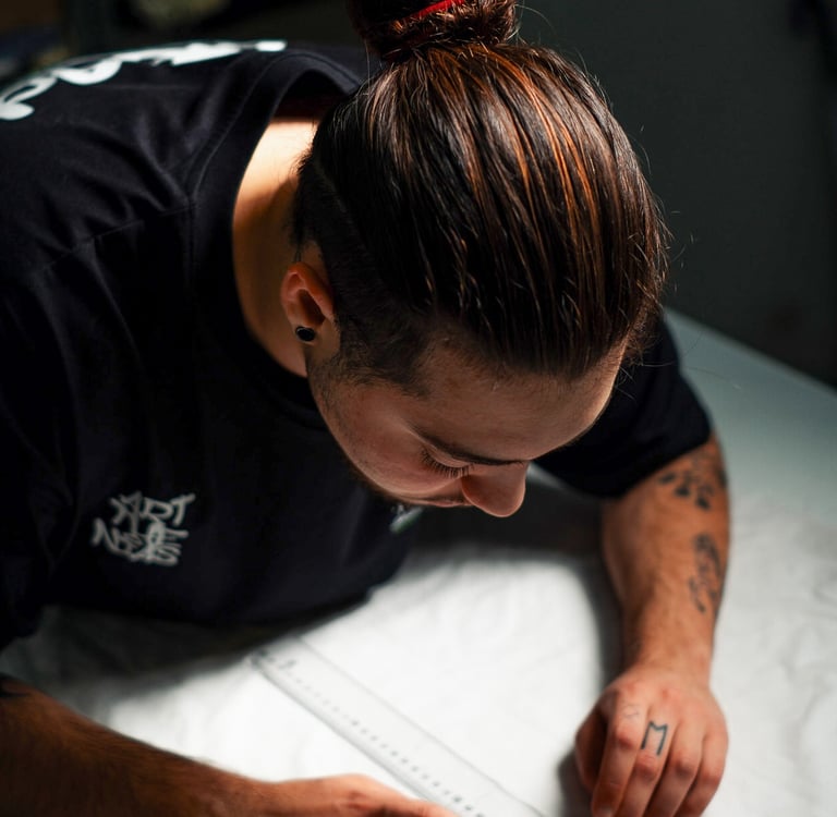 a man is looking down at a white sheet of paper
