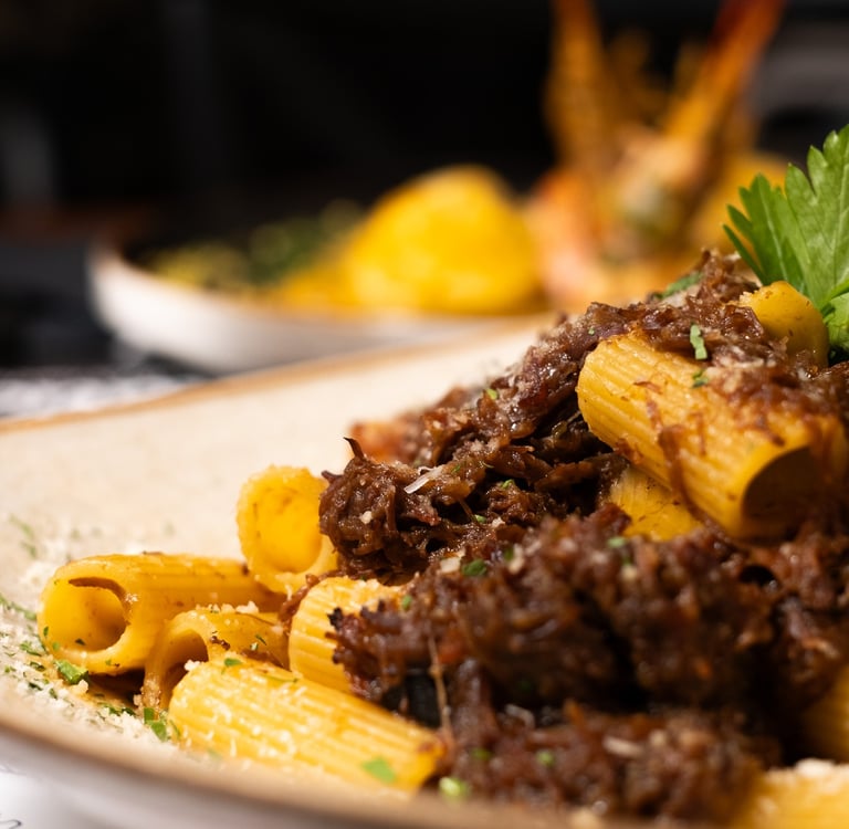 a plate of pasta with pasta and meat