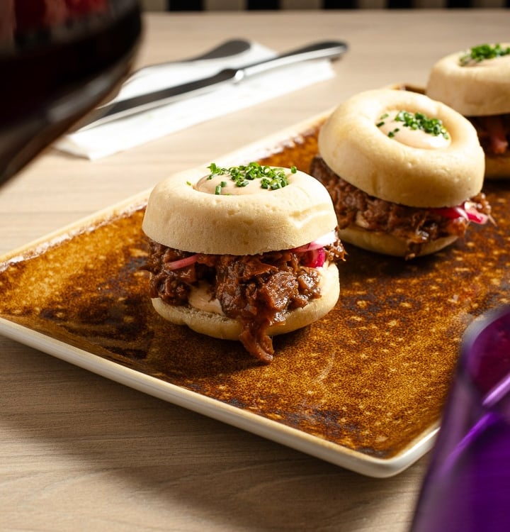 a plate of food and wine glasses on a table