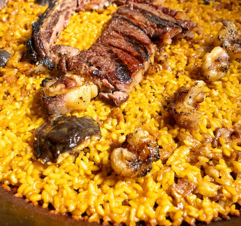 a large pan of food with meat and vegetables