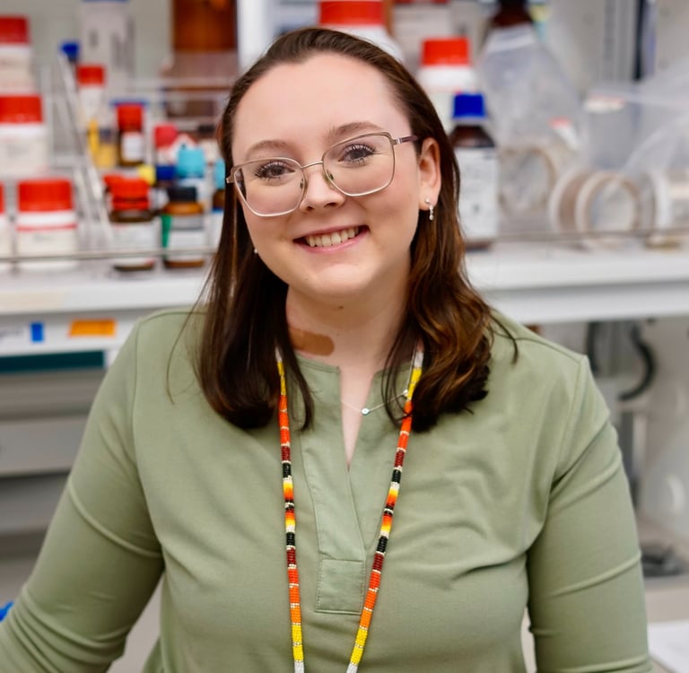 Baylie Phillips portrait photo in laboratory with bottles in the background