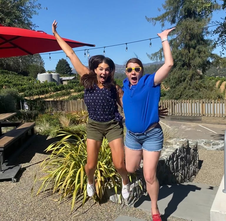 Image of two women jumping for joy.