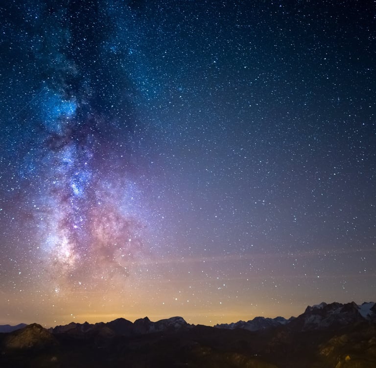 Milky Way galaxy over snowy mountains
