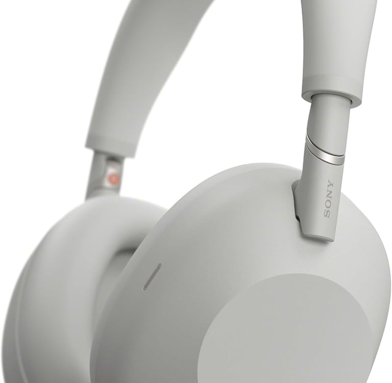 Sony WH-1000XM5 wireless noise-canceling headphones in silver with plush earcups and padded headband.