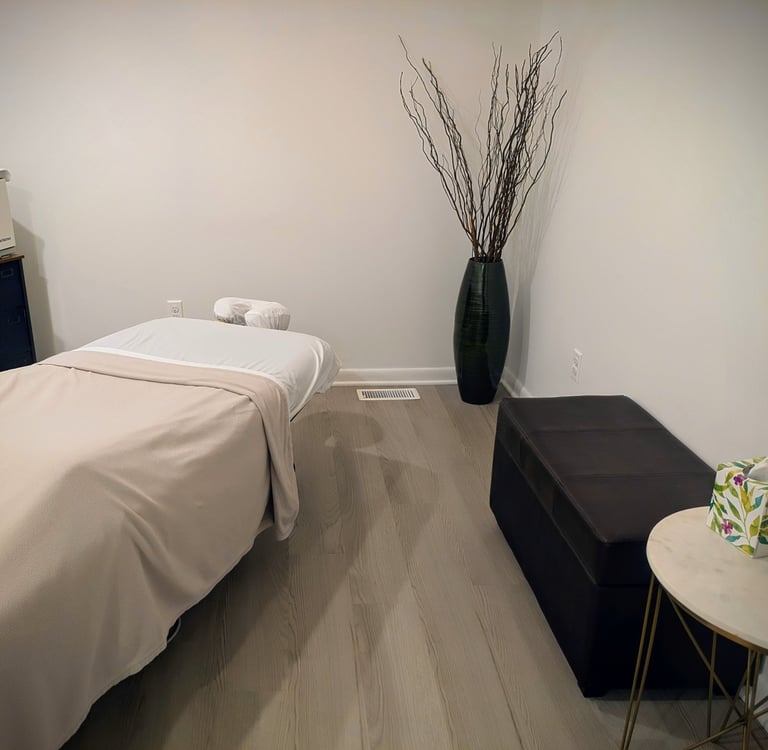 massage room with table and bench