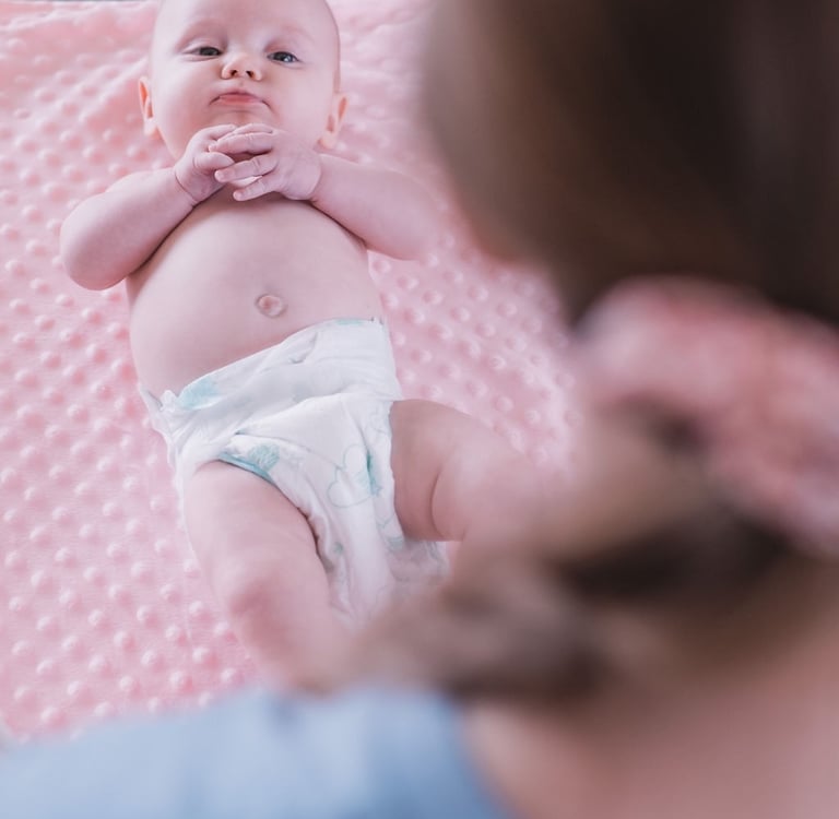 Baby lying on a pink blanket during a Rock & Roll Baby massage class in Radwinter near Saffron Walden
