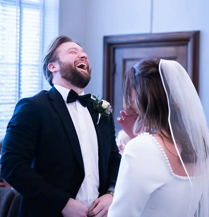 groom laughing during wedding ceremony at Islington Town Hall