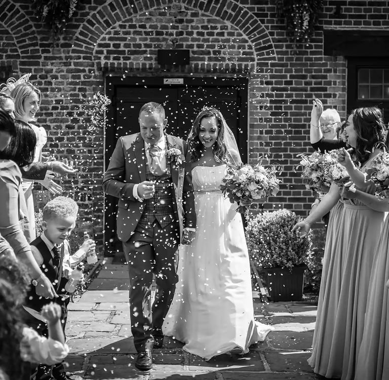 newly-weds having their confetti moment at Tudor barn Eltham