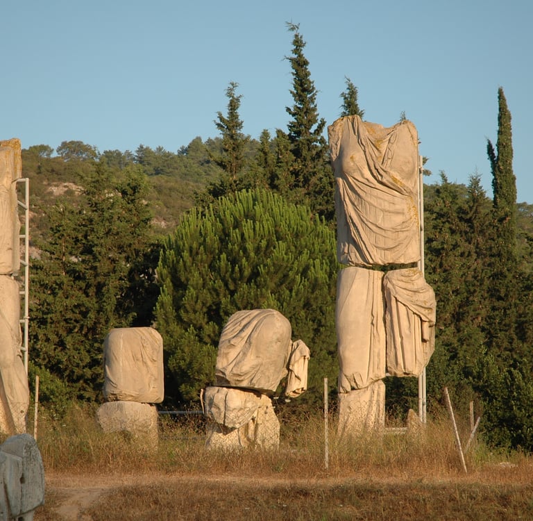 Ancient Greek limestone draped statues at an archaeological site in Claros, Turkey.