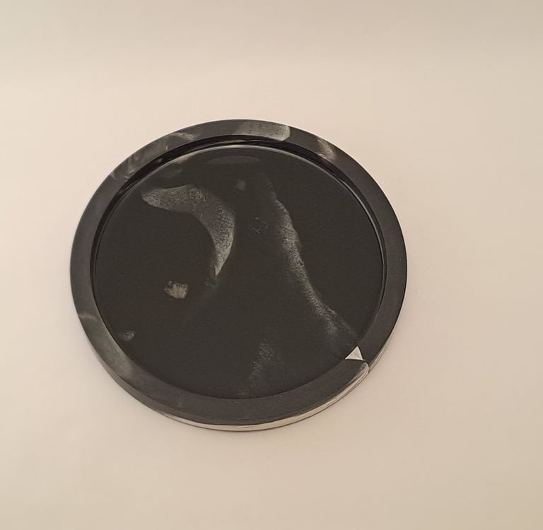 Handcrafted circular dark tray with black resin interior featuring misty white marbled swirls