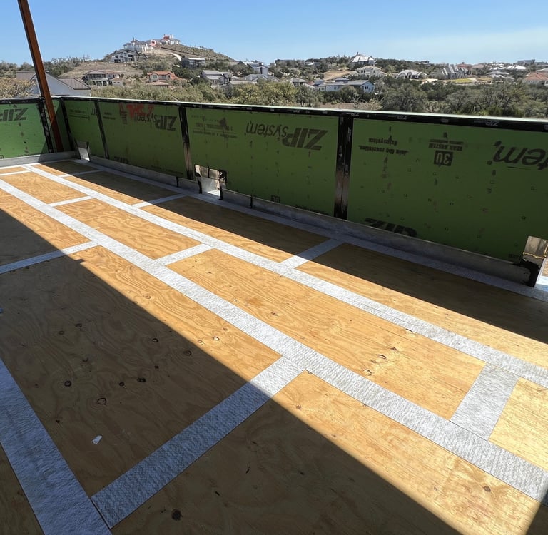 Waterproofing plywood joints before apply membrane and concrete on custom home balcony.