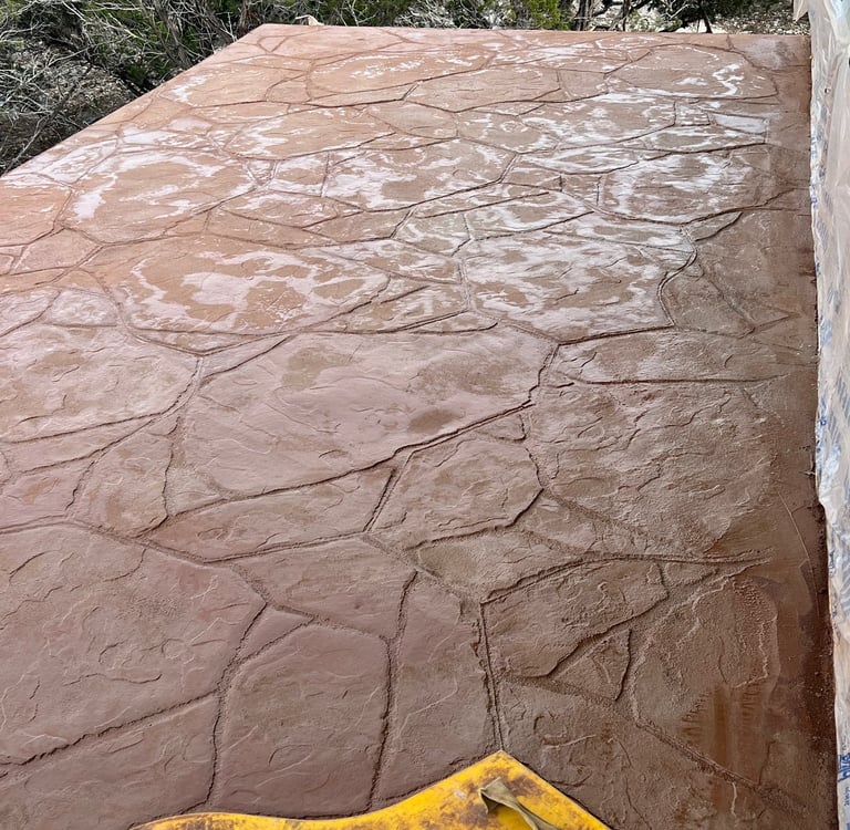 Colored and stamped concrete balcony after waterproofing deck.