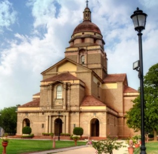 a church with a clock tower in the background
