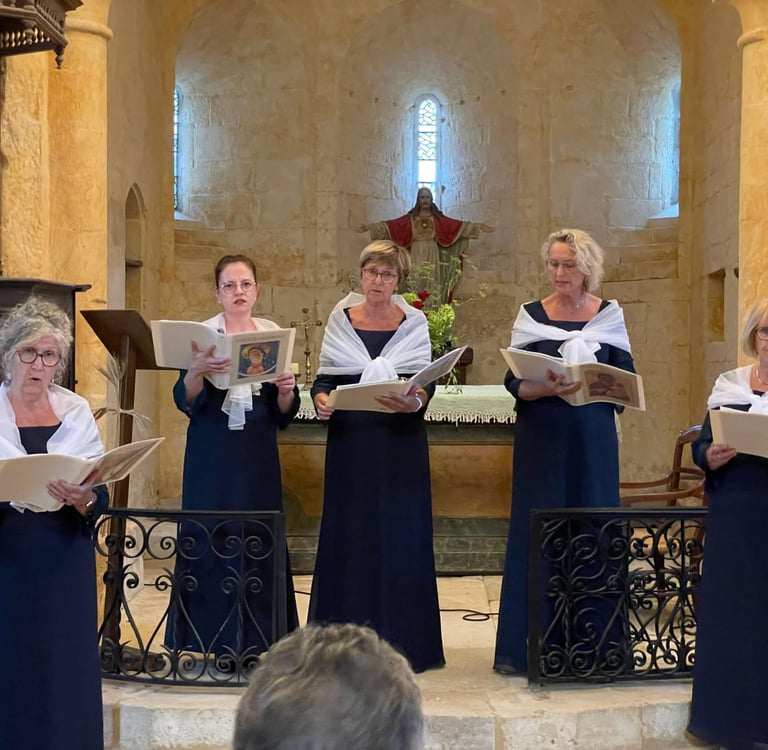 A women's vocal ensemble wearing blue gowns performing choral music inside a historic stone church.