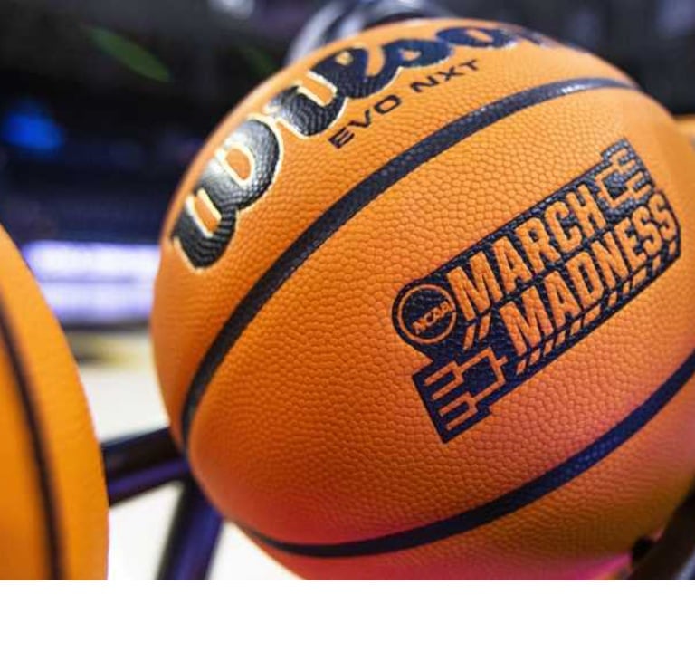 NCAA March Madness basketball on a rack during a college basketball tournament game.