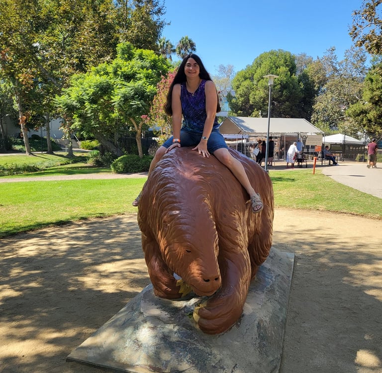 Andrielle riding giant ground sloth statue