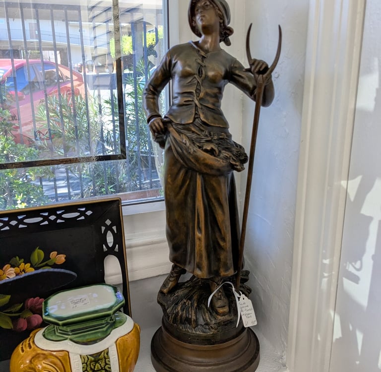 Antique bronze statue of a peasant woman.