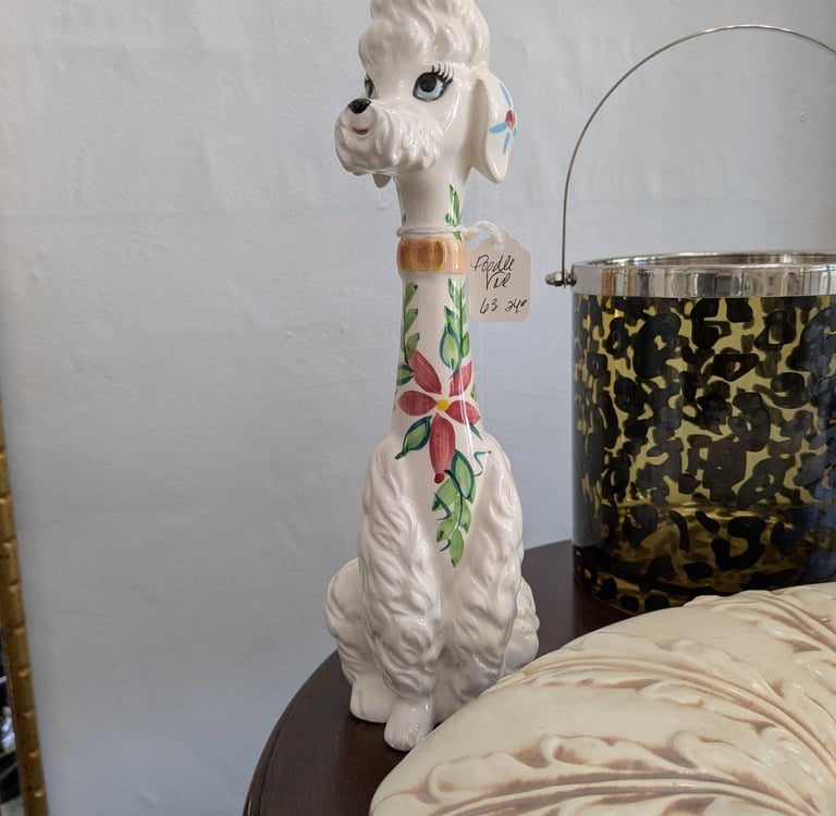 Vintage white ceramic poodle figurine with floral hand-painted details on a long neck.